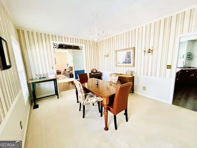 dining area featuring carpet floors and a chandelier