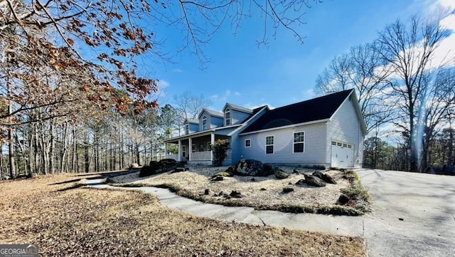 view of property exterior with a garage and a porch