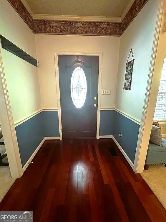 foyer featuring hardwood / wood-style flooring and ornamental molding