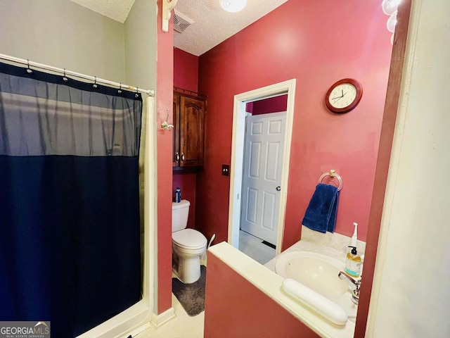 bathroom with vanity, a shower with shower curtain, a textured ceiling, and toilet