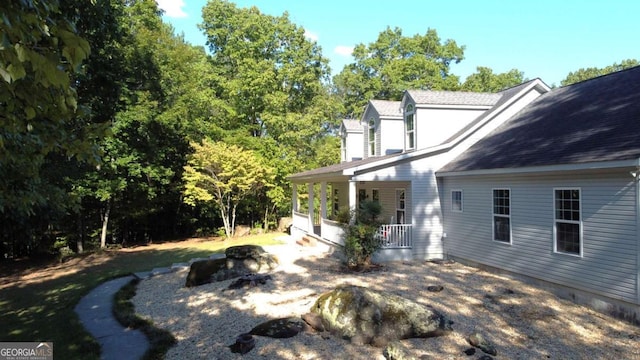 view of side of home with a porch