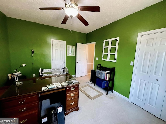 office space featuring ceiling fan and a textured ceiling