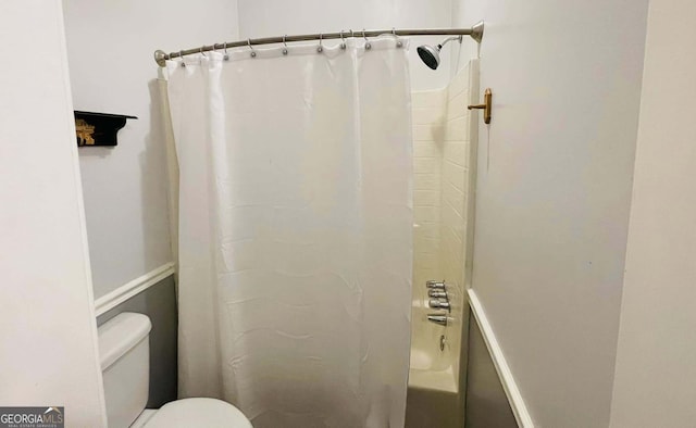 bathroom with shower / bath combination with curtain and toilet