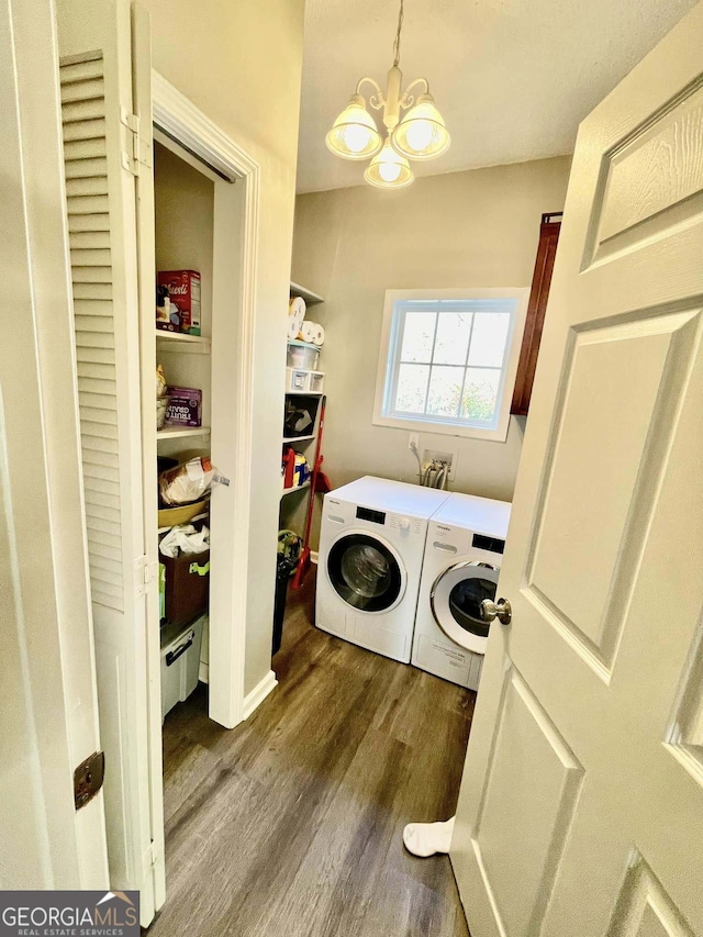 laundry area featuring separate washer and dryer, a notable chandelier, dark hardwood / wood-style flooring, and baseboard heating