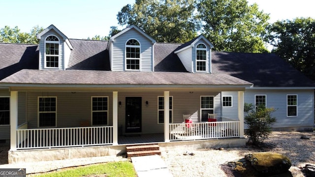 cape cod home featuring a porch