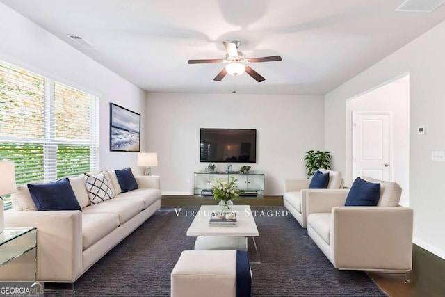 living room with ceiling fan and dark hardwood / wood-style floors