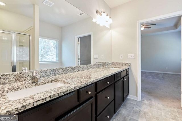 bathroom featuring vanity, a shower with door, and ceiling fan