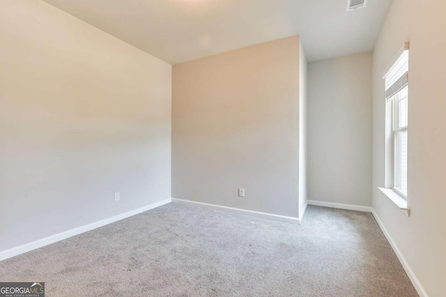 carpeted empty room with a healthy amount of sunlight