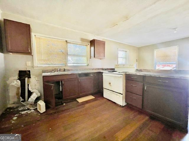 kitchen with white electric range and dark wood-type flooring