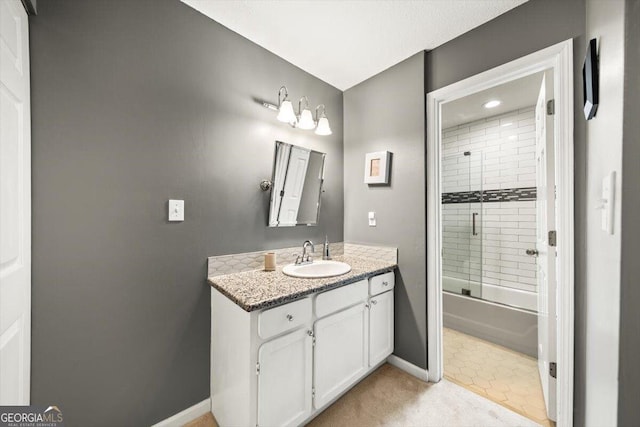 bathroom with vanity and enclosed tub / shower combo