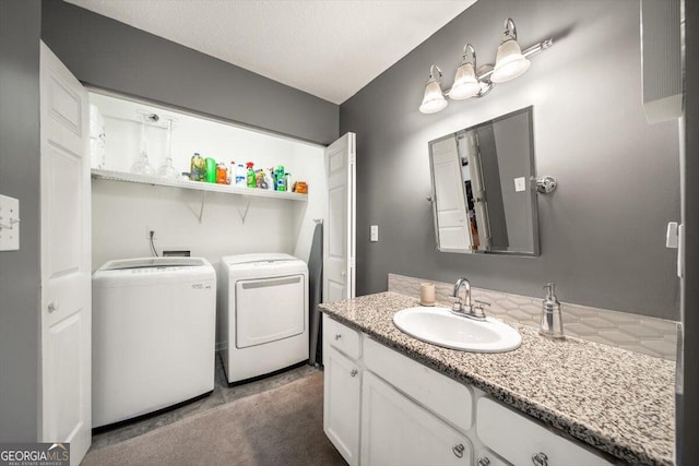 interior space with washing machine and clothes dryer and vanity