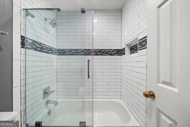 bathroom with bath / shower combo with glass door