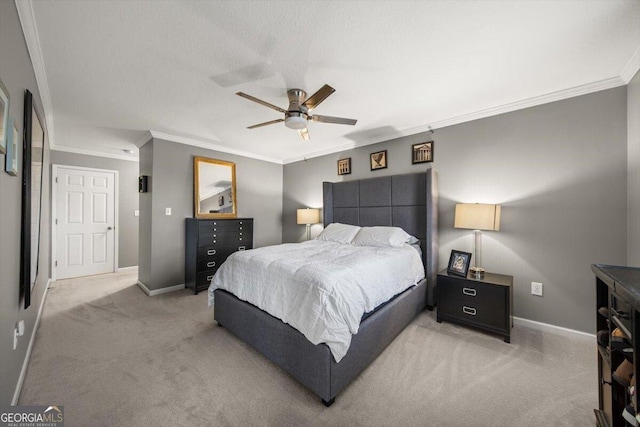 carpeted bedroom with ceiling fan and crown molding