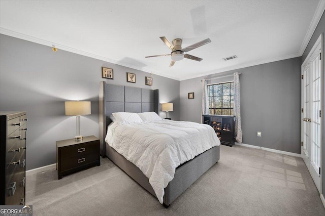 bedroom featuring ceiling fan, light colored carpet, and ornamental molding