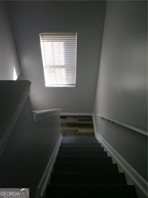 stairs featuring hardwood / wood-style floors