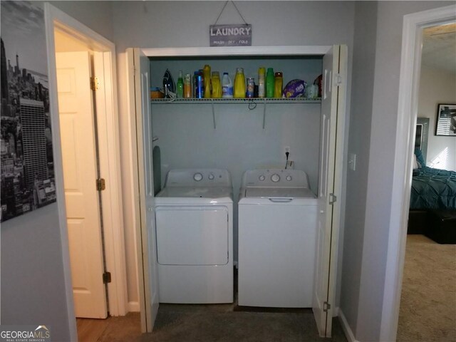 washroom featuring washing machine and dryer and dark colored carpet