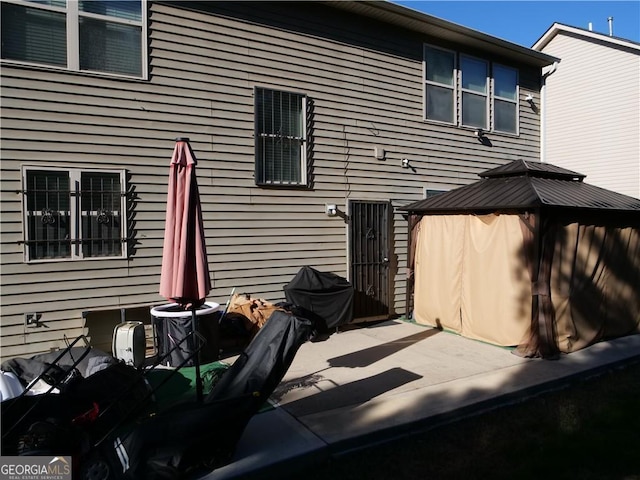 back of property with a gazebo