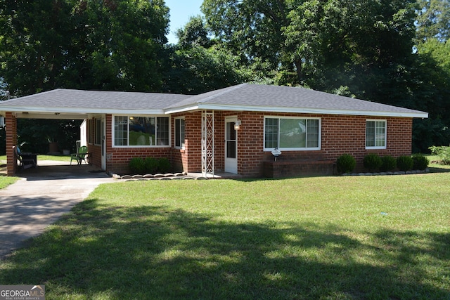 ranch-style home featuring a front lawn and a carport