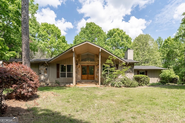 single story home featuring french doors and a front lawn