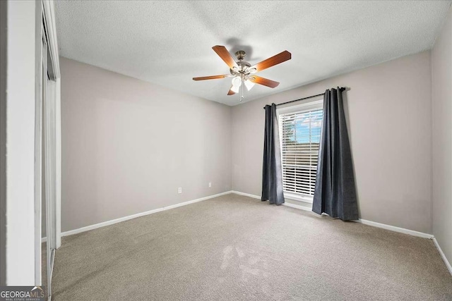 carpeted spare room featuring a textured ceiling