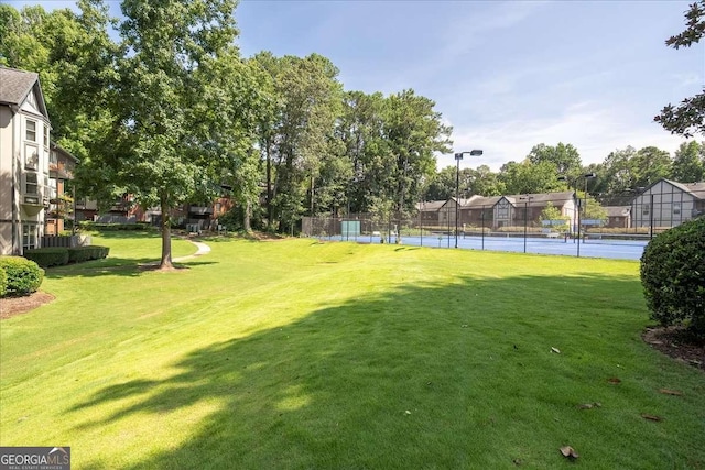 view of yard featuring tennis court