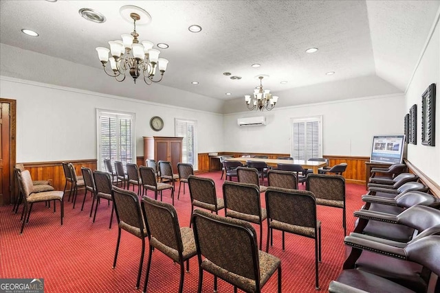 dining area with wood walls, an AC wall unit, a textured ceiling, a notable chandelier, and carpet floors