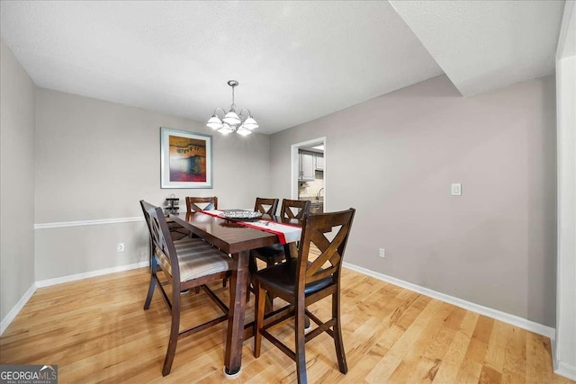 dining space featuring a chandelier and light hardwood / wood-style flooring