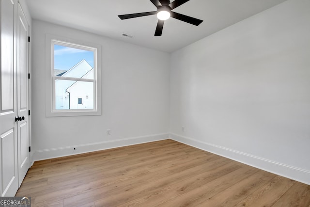 spare room with ceiling fan and light wood-type flooring