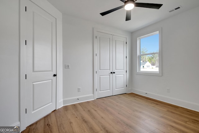 unfurnished bedroom with ceiling fan and light hardwood / wood-style floors