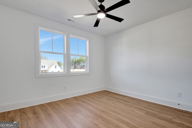 spare room with ceiling fan and light wood-type flooring