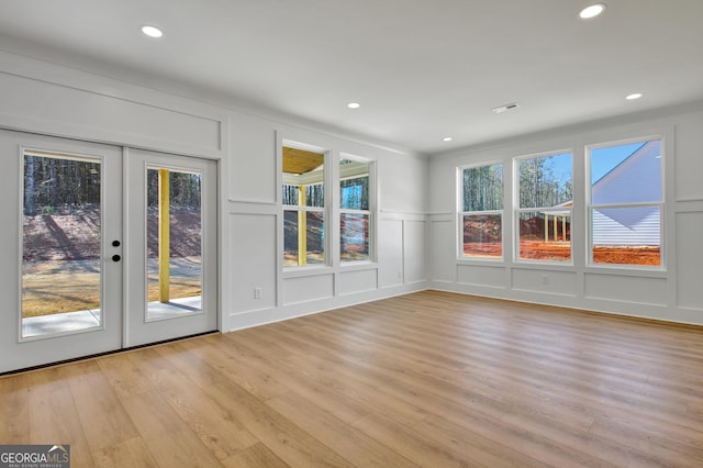 interior space featuring a healthy amount of sunlight, french doors, and light wood-type flooring