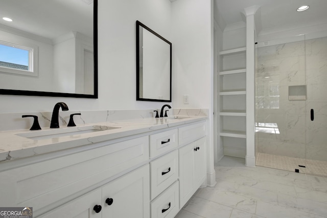 bathroom with a shower with shower door, vanity, and ornamental molding