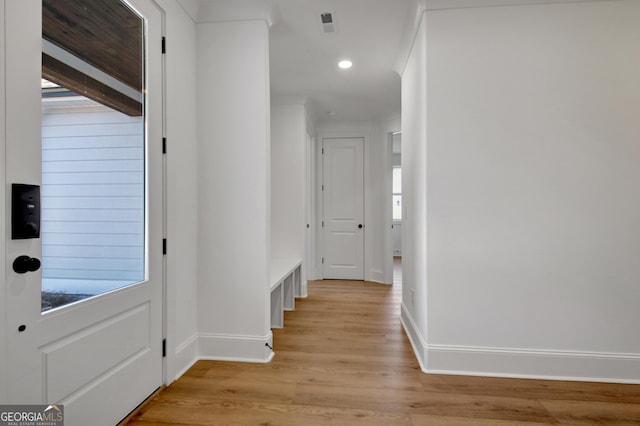 hallway with light hardwood / wood-style floors