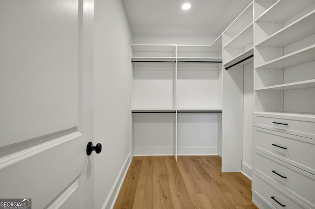 spacious closet with light hardwood / wood-style floors