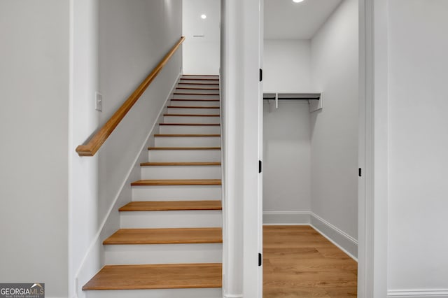 stairs featuring hardwood / wood-style floors