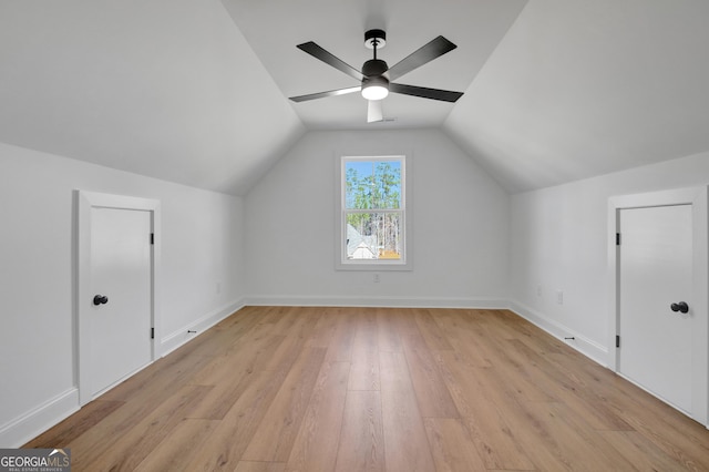 additional living space featuring ceiling fan, light wood-type flooring, and vaulted ceiling