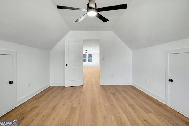 additional living space with light wood-type flooring, ceiling fan, and lofted ceiling