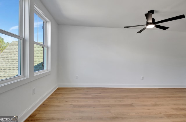 unfurnished room with light hardwood / wood-style floors, a wealth of natural light, and ceiling fan