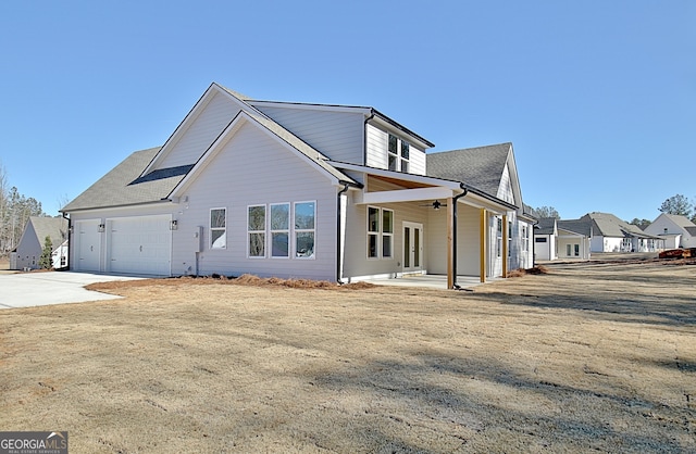 exterior space featuring ceiling fan and a garage