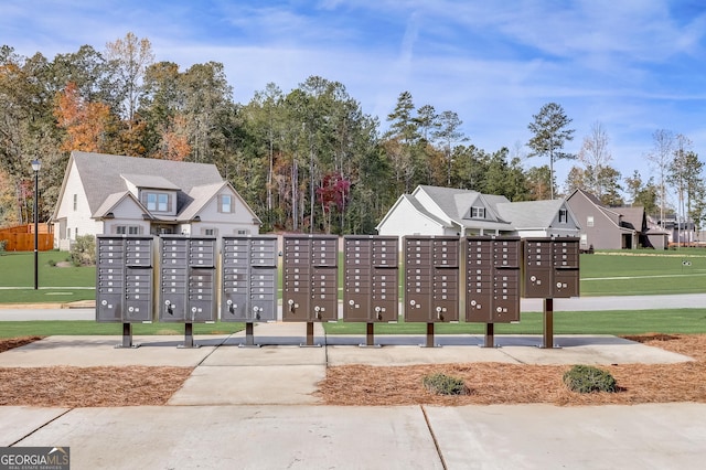 surrounding community featuring a lawn and mail boxes