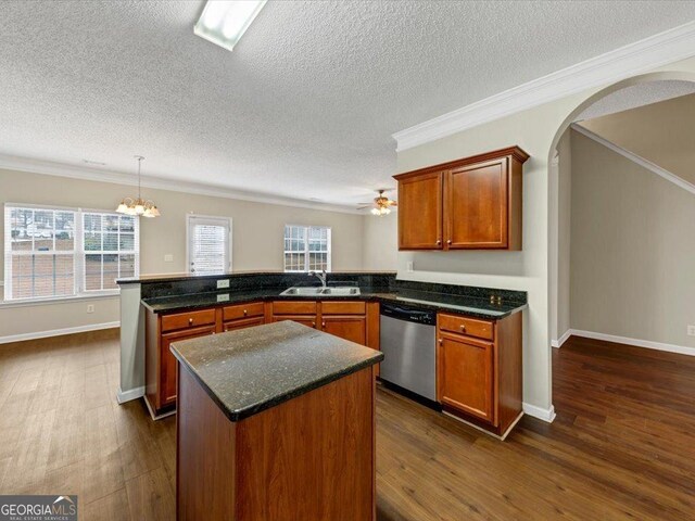 kitchen featuring appliances with stainless steel finishes, decorative light fixtures, dark hardwood / wood-style floors, ornamental molding, and a notable chandelier