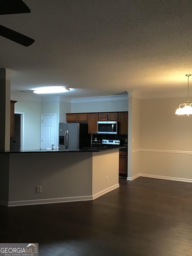 kitchen with ceiling fan with notable chandelier, crown molding, decorative backsplash, and stainless steel appliances