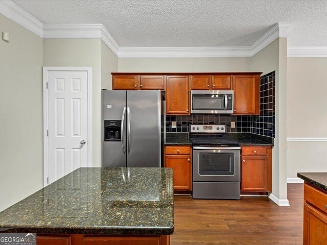 kitchen featuring a textured ceiling, crown molding, stainless steel dishwasher, and sink