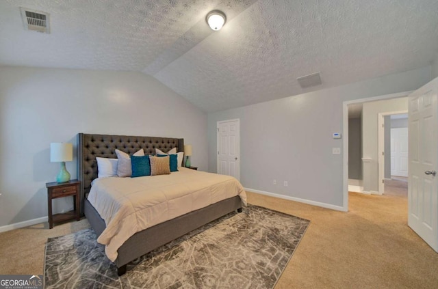 bedroom featuring carpet flooring, a textured ceiling, and vaulted ceiling