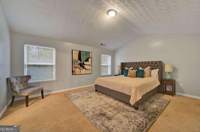 bedroom with a textured ceiling, light colored carpet, multiple windows, and lofted ceiling