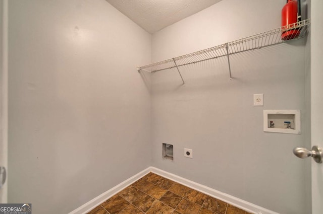 laundry room featuring washer hookup, electric dryer hookup, and a textured ceiling