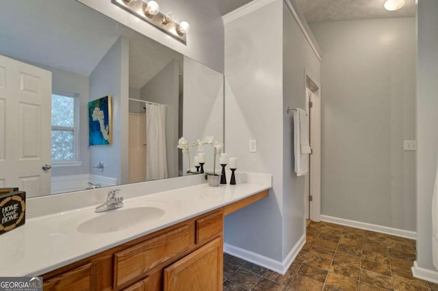 bathroom with plus walk in shower, vanity, and a textured ceiling