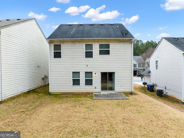 back of house featuring a patio area, a yard, and central AC