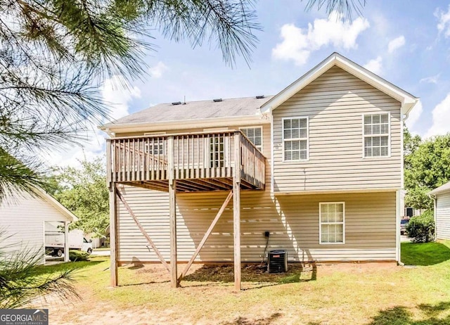 back of property featuring a yard and a deck