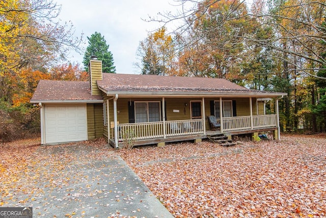 view of front of home featuring covered porch and a garage